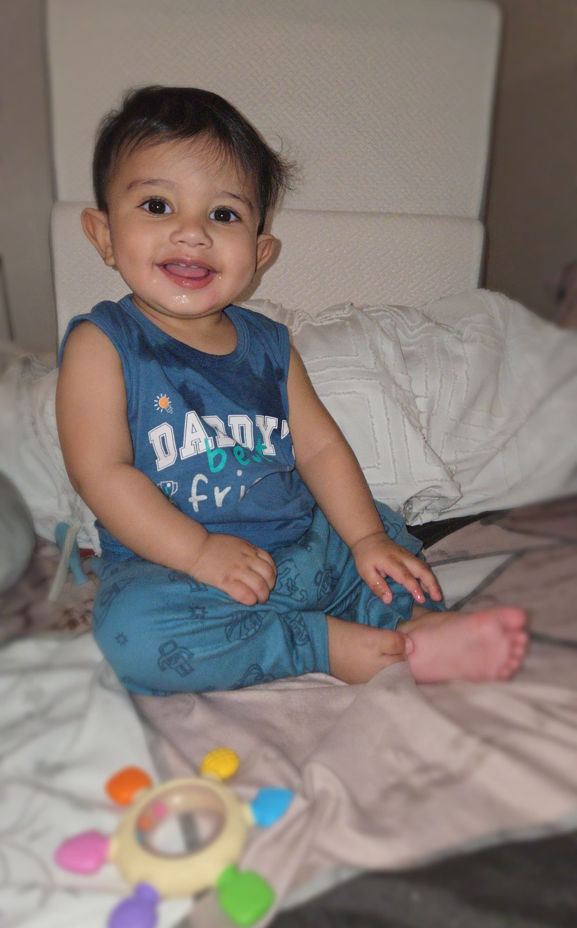 Salahaddin sitting up on a bed